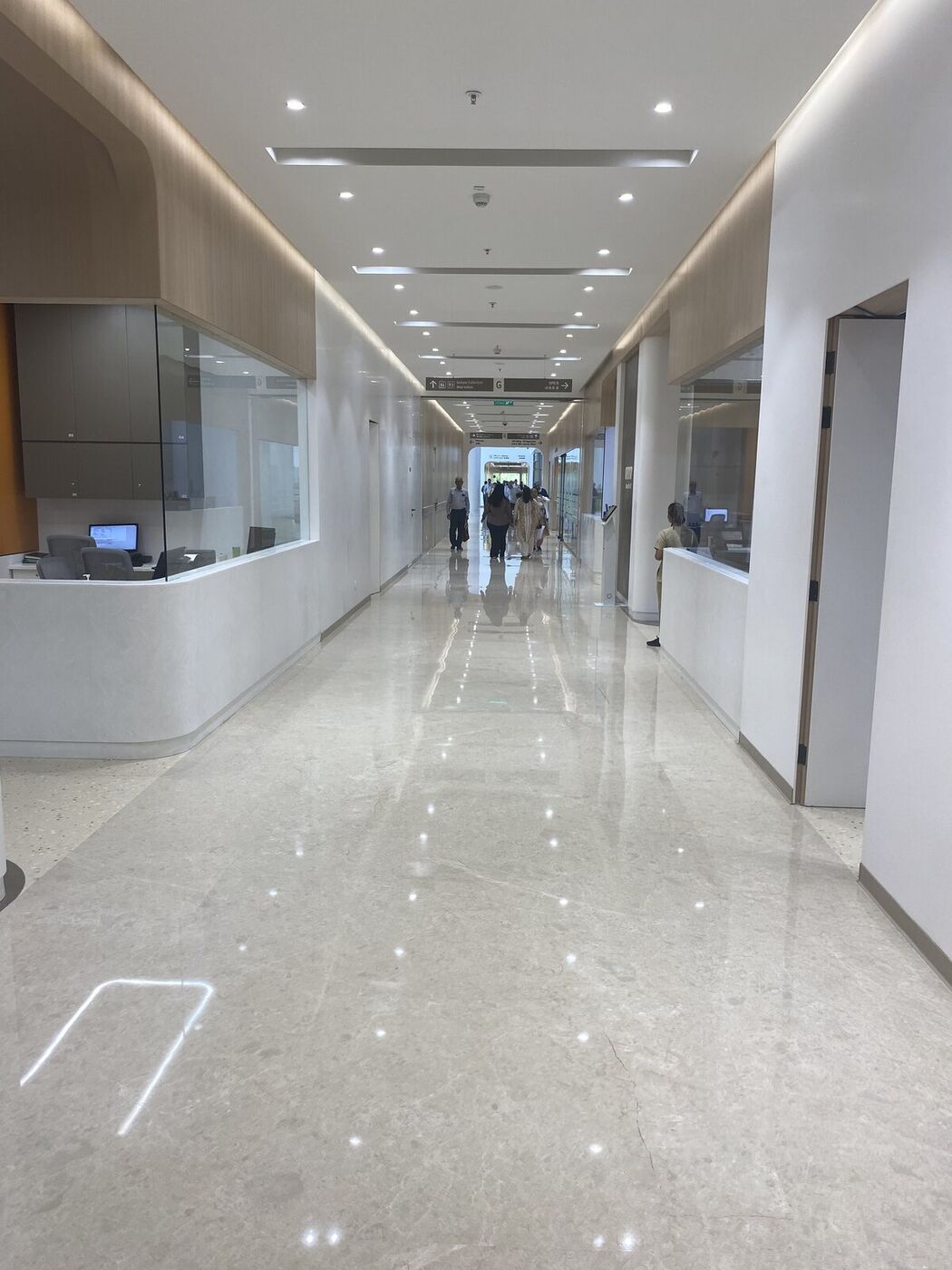 Bright patient-wing corridor and nursing station in India