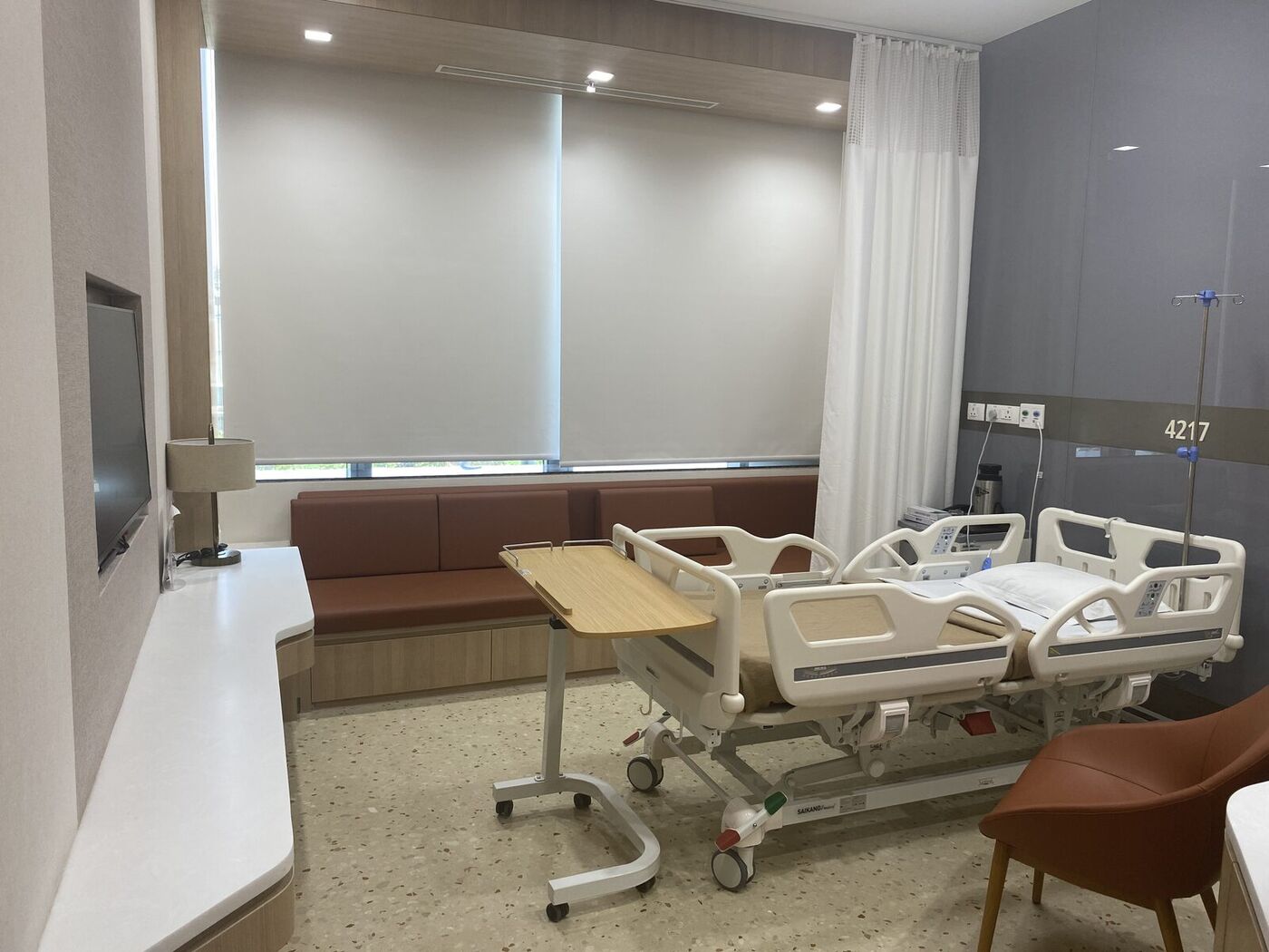 A private recovery room with companion seating and a window view, India